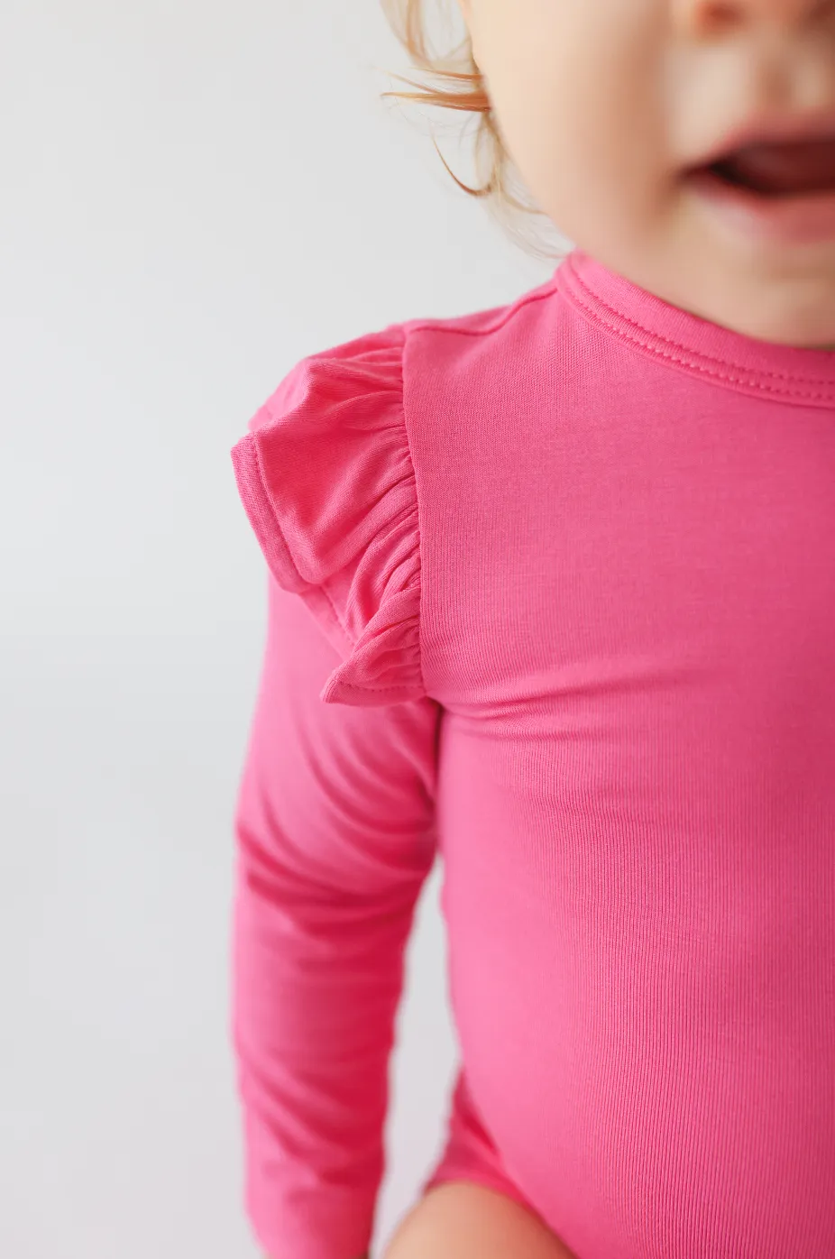 Posh Peanut Long Sleeve Girls Ruffled Bodysuit in Posh Hot Pink